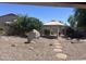 Expansive backyard featuring desert landscaping, a rock feature, and a charming gazebo for outdoor relaxation at 4581 E Apricot Ln, Gilbert, AZ 85298
