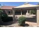Backyard features a covered patio, desert landscaping, and ample privacy at 4581 E Apricot Ln, Gilbert, AZ 85298