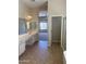 Bright bathroom with tile floors, double vanity and a separate water closet at 4581 E Apricot Ln, Gilbert, AZ 85298