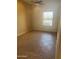 Neutral bedroom with tile flooring, a ceiling fan, and natural light from the window at 4581 E Apricot Ln, Gilbert, AZ 85298