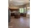 Spacious kitchen featuring dark wood cabinets, granite countertops, an island, and stainless steel appliances at 4581 E Apricot Ln, Gilbert, AZ 85298