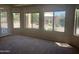 Bright living room featuring neutral walls, carpeted floors, and a wall of windows at 4581 E Apricot Ln, Gilbert, AZ 85298