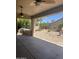 Covered patio with built-in grill overlooking a large backyard with mature trees and desert landscaping at 4581 E Apricot Ln, Gilbert, AZ 85298