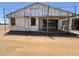 Image of the new home's back exterior showing incomplete patio and framework at 46850 W Old Timer Rd, Maricopa, AZ 85139