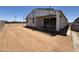 Image of the new home's back exterior showing incomplete patio and framework at 46850 W Old Timer Rd, Maricopa, AZ 85139