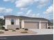 Beautiful single-story home features a three car garage, desert landscaping, and a neutral color palette at 46850 W Old Timer Rd, Maricopa, AZ 85139