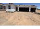 Image of new home's exterior with two-car garage, window openings, and the initial stages of roof installation at 46850 W Old Timer Rd, Maricopa, AZ 85139