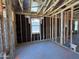 A view of the home's incomplete interior framework, including window and plumbing elements at 46850 W Old Timer Rd, Maricopa, AZ 85139