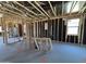 Interior framing showing studs, wiring and window openings in an incomplete new home at 46850 W Old Timer Rd, Maricopa, AZ 85139