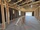 Interior framing showing studs, wiring and window openings in an incomplete new home at 46850 W Old Timer Rd, Maricopa, AZ 85139