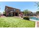 Backyard oasis featuring artificial turf, a pool with lounge chairs, and privacy fencing at 5110 E Mark Ln, Cave Creek, AZ 85331