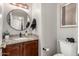 Small bathroom with a round mirror, and dark granite countertop at 5110 E Mark Ln, Cave Creek, AZ 85331