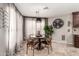 Charming dining area with round table, unique lighting, and sheer curtains at 5110 E Mark Ln, Cave Creek, AZ 85331
