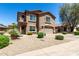 Two-story home with a two-car garage, desert landscaping, and a 'for sale' sign on a sunny day at 5110 E Mark Ln, Cave Creek, AZ 85331