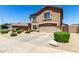 Two-story home with two car garage and neutral stucco finish featuring desert landscaping and a clear blue sky at 5110 E Mark Ln, Cave Creek, AZ 85331