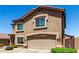Two-story home showcasing a neutral stucco exterior, a tiled roof, and an attached two-car garage at 5110 E Mark Ln, Cave Creek, AZ 85331
