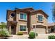Charming home featuring a two-car garage, a welcoming front door with wreath, and desert landscaping at 5110 E Mark Ln, Cave Creek, AZ 85331