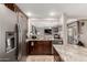 Kitchen features stainless steel appliances and sink; open to the living area at 5110 E Mark Ln, Cave Creek, AZ 85331