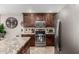 Modern kitchen boasts stainless steel appliances, dark wood cabinets, and island at 5110 E Mark Ln, Cave Creek, AZ 85331