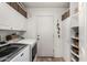Bright laundry room with cabinetry and plenty of storage space at 5110 E Mark Ln, Cave Creek, AZ 85331