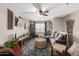 Large living room with gray couch, large window, and a fan at 5110 E Mark Ln, Cave Creek, AZ 85331