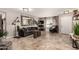 Spacious living room with dark leather seating, mirror, and neutral flooring at 5110 E Mark Ln, Cave Creek, AZ 85331