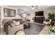 Spacious living room with cozy seating, stairs, and large TV for entertaining guests at 5110 E Mark Ln, Cave Creek, AZ 85331