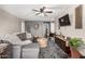 Comfortable living room featuring stylish decor, ceiling fan, and mounted television at 5110 E Mark Ln, Cave Creek, AZ 85331