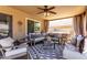 Well-furnished covered patio with comfortable seating, ceiling fan, and outdoor decor offers perfect entertaining area at 5110 E Mark Ln, Cave Creek, AZ 85331