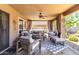 Spacious covered patio with sectional seating, ceiling fan, and decorative rug offers relaxing outdoor escape at 5110 E Mark Ln, Cave Creek, AZ 85331