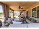 Inviting covered patio with comfortable seating, ceiling fan, and stylish decor creates perfect outdoor living space at 5110 E Mark Ln, Cave Creek, AZ 85331