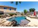 Backyard showcasing a pool with a rock waterfall, lounge chairs, and privacy fencing at 5110 E Mark Ln, Cave Creek, AZ 85331