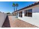 Spacious backyard featuring gravel landscaping, a covered patio, and views of the clear blue sky at 5125 W Wickiup Ln, Glendale, AZ 85308