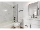 Modern bathroom with a vanity, soaking tub, and marble-look tile surround at 5125 W Wickiup Ln, Glendale, AZ 85308