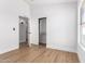 Bedroom featuring wood-look floors leading to a bathroom and sliding closet at 5125 W Wickiup Ln, Glendale, AZ 85308