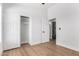 Bedroom featuring bright white walls, wood-look floors, and closet at 5125 W Wickiup Ln, Glendale, AZ 85308