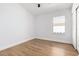 Bright bedroom featuring wood-look floors, closet, and ample natural light from the window at 5125 W Wickiup Ln, Glendale, AZ 85308