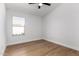 Bright bedroom featuring wood-look floors and ample natural light from the window at 5125 W Wickiup Ln, Glendale, AZ 85308