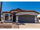 Charming single-story home with a terracotta roof and a well-maintained two-car garage at 5125 W Wickiup Ln, Glendale, AZ 85308