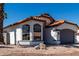 Charming single-story home featuring a terracotta roof, arched windows, and low-maintenance landscaping at 5125 W Wickiup Ln, Glendale, AZ 85308