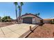 Lovely single-story house showcasing a driveway, terracotta roof, and desert landscaping at 5125 W Wickiup Ln, Glendale, AZ 85308