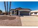 Inviting single-story home with a two-car garage, terracotta roof, and desert-friendly front yard at 5125 W Wickiup Ln, Glendale, AZ 85308