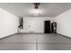 Clean and spacious garage with painted floor, storage options, and convenient access to the home at 5125 W Wickiup Ln, Glendale, AZ 85308