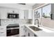 Updated kitchen featuring white cabinets, stainless steel appliances, and a sink overlooking a window at 5125 W Wickiup Ln, Glendale, AZ 85308