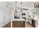 Modern kitchen featuring stainless appliances, a center island, and sleek white cabinets at 5125 W Wickiup Ln, Glendale, AZ 85308