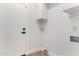 Clean laundry area with bright white walls, utility sink, and storage at 5125 W Wickiup Ln, Glendale, AZ 85308