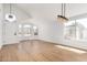 Bright living room showcasing new floors, a white front door, and large windows for lots of natural light at 5125 W Wickiup Ln, Glendale, AZ 85308