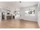 Bright and spacious living room with wood floors, large windows, and an open floor plan to the kitchen at 5125 W Wickiup Ln, Glendale, AZ 85308