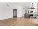 Bright living room area showcasing wood floors and an open layout connecting to the modern kitchen at 5125 W Wickiup Ln, Glendale, AZ 85308