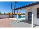 A covered patio area with view of the pool and lush tropical landscaping at 5125 W Wickiup Ln, Glendale, AZ 85308
